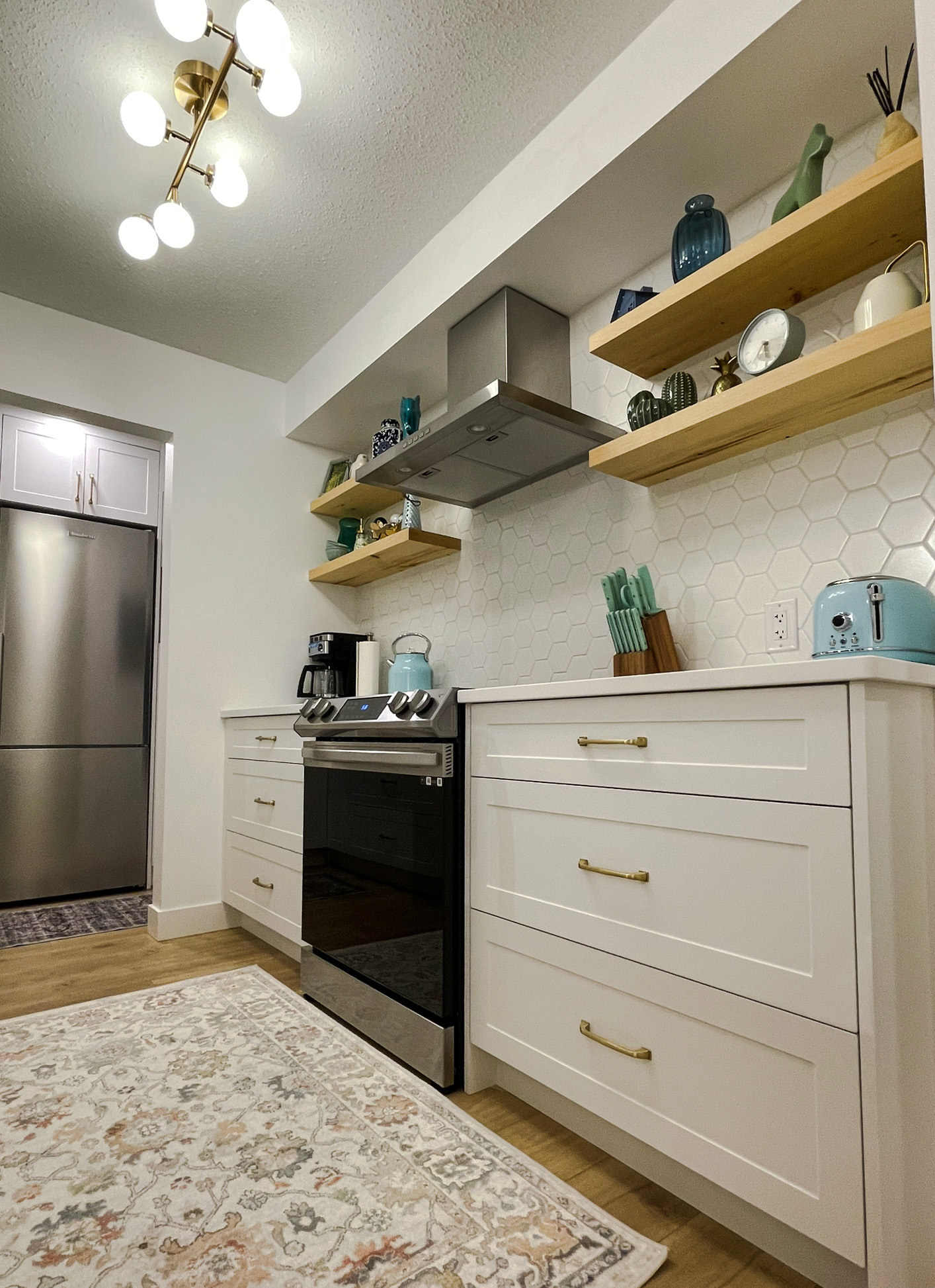 Shaker White Custom Kitchen Cabinet, contemporary hardware accents & Floating Shelves in Downtown Vancouver, BC.