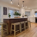Overall kitchen with maple island and Dream White perimeter cabinets & crisp cabinetry design in Murrayville, Langley, BC.