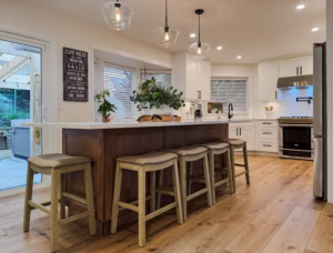 Overall kitchen with maple island and Dream White perimeter cabinets & crisp cabinetry design in Murrayville, Langley, BC.