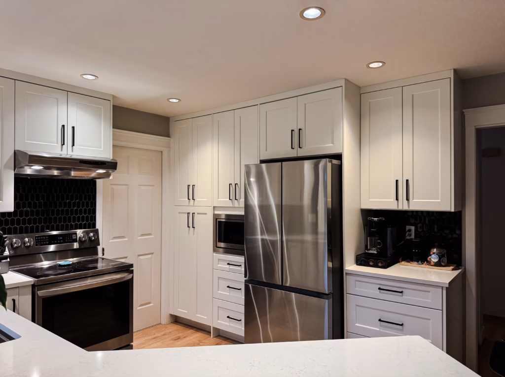 White shaker pantry cabinets and Vicostone Polaris quartz countertop in a Surrey kitchen renovation.