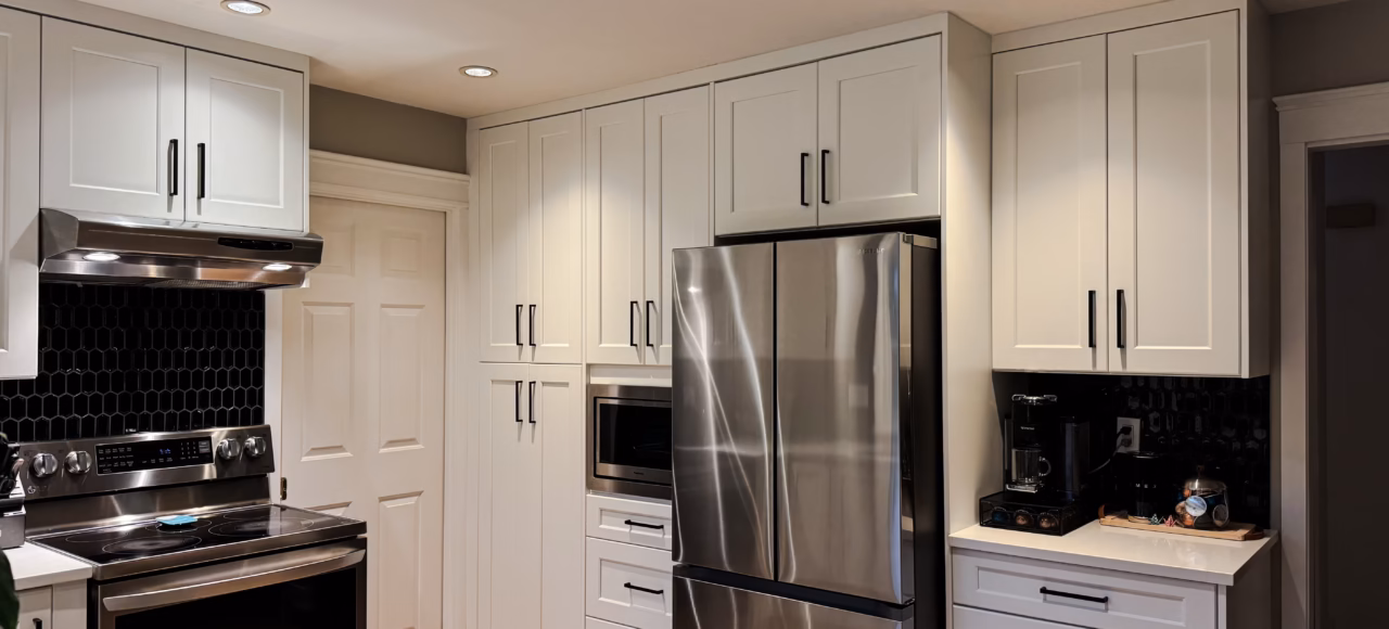 White shaker pantry cabinets and Vicostone Polaris quartz countertop in a Surrey kitchen renovation.