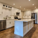 Langley kitchen cabinets with Dream White Shaker doors, large island and open-concept layout in Brookswood.