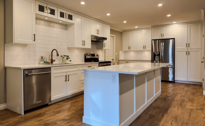 Langley kitchen cabinets with Dream White Shaker doors, large island and open-concept layout in Brookswood.